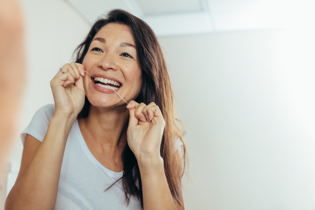 Woman Flossing Teeth