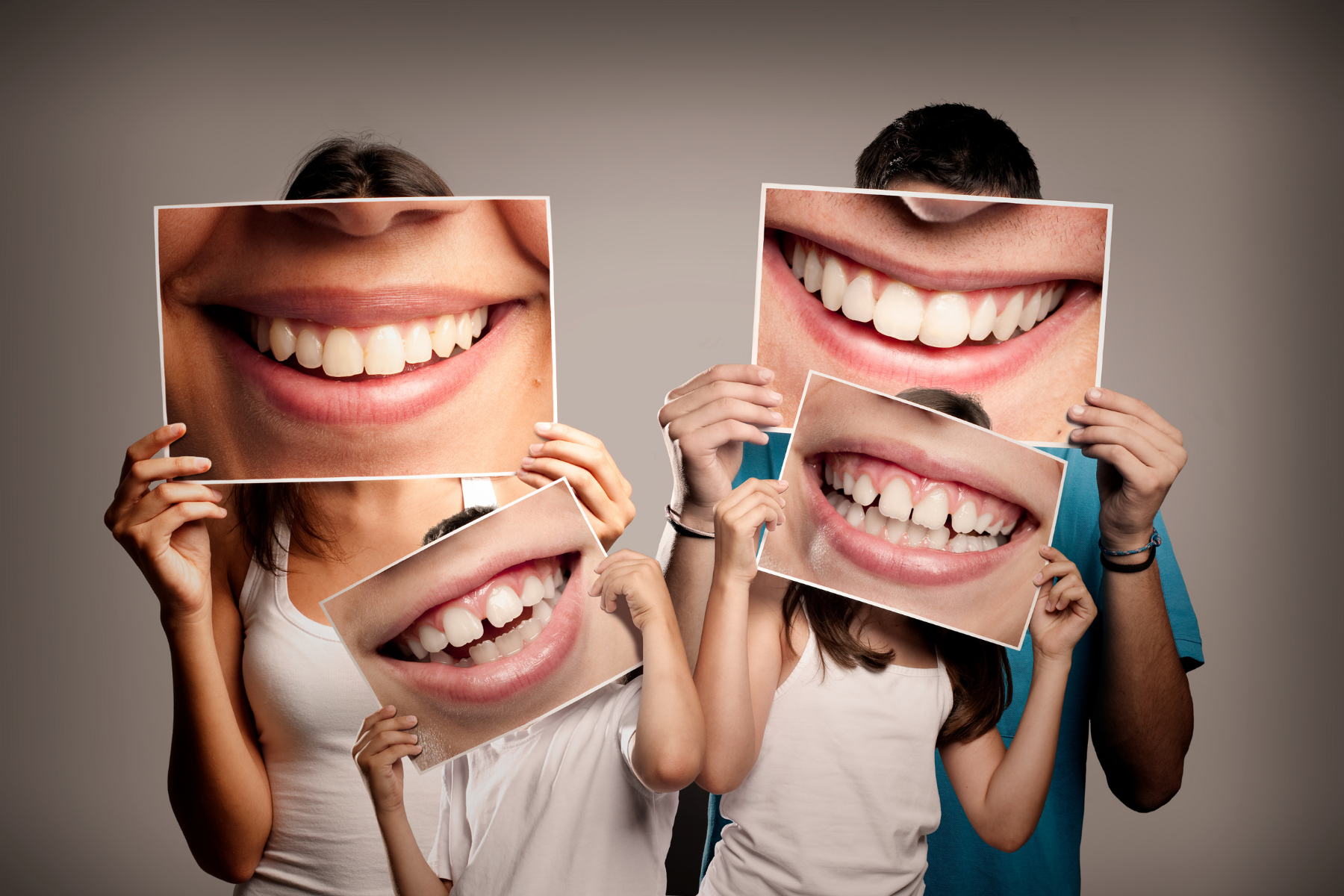 family holding pictures of smiles