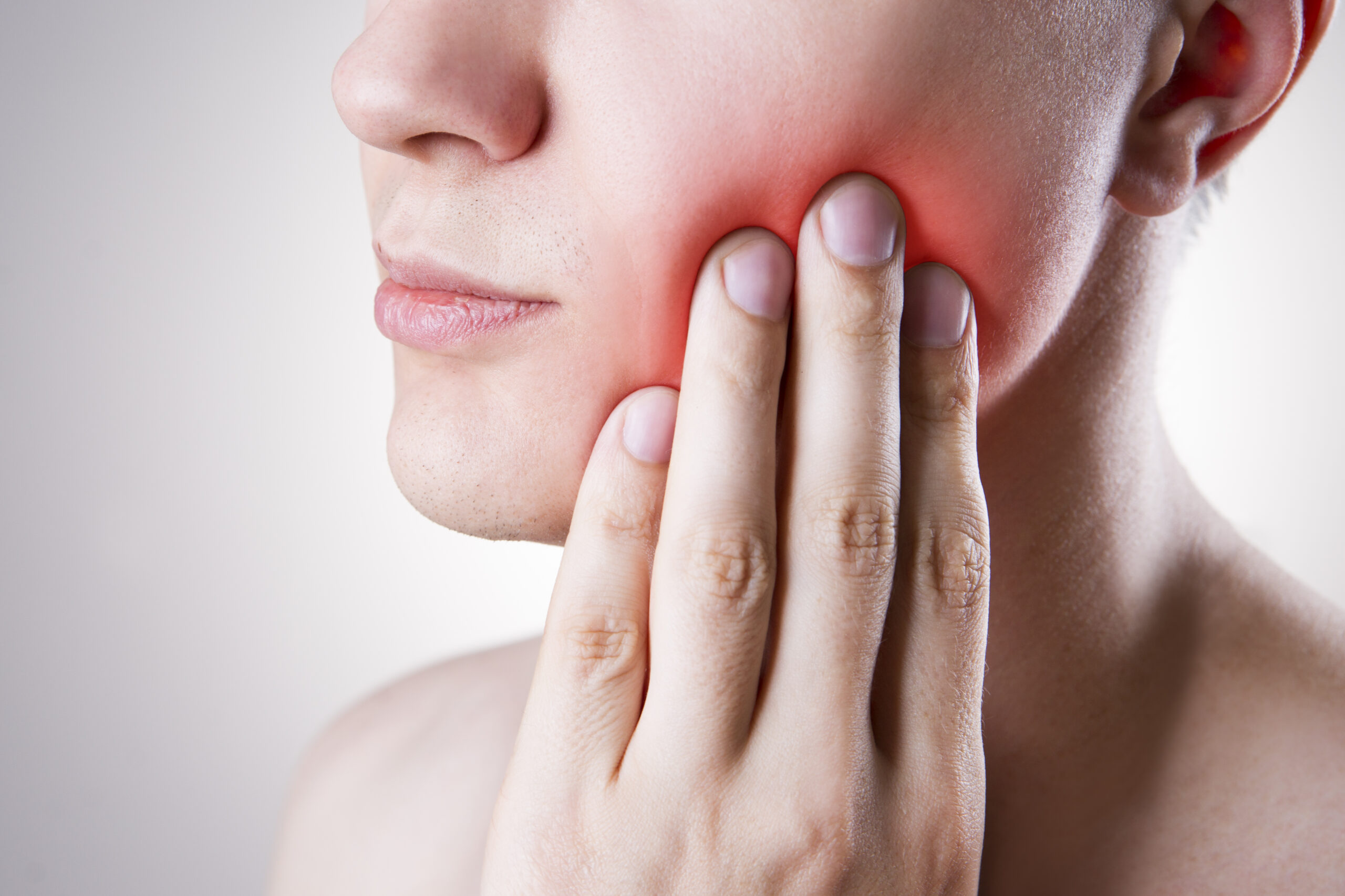 Woman Touching Jaw in Pain